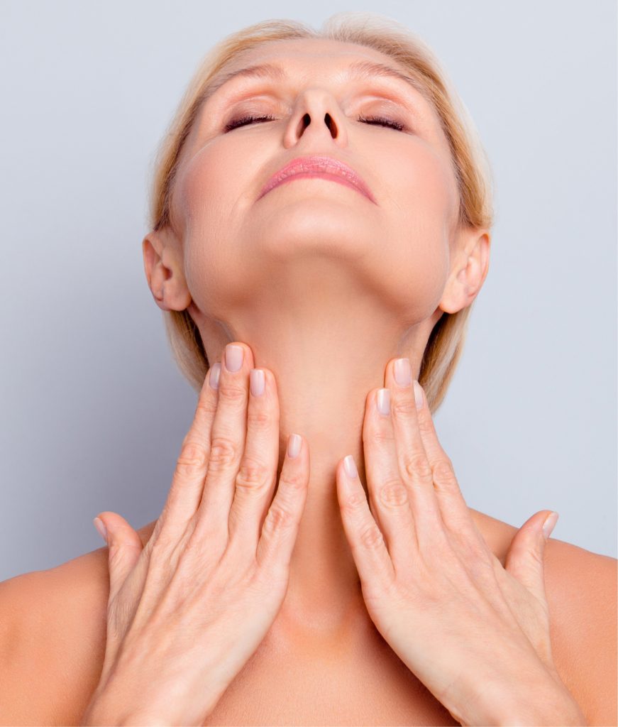 Older woman touching her neck