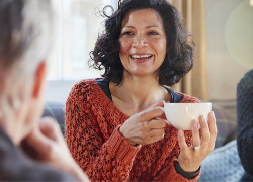 Happy facial resurfacing patient holding a cup of tea