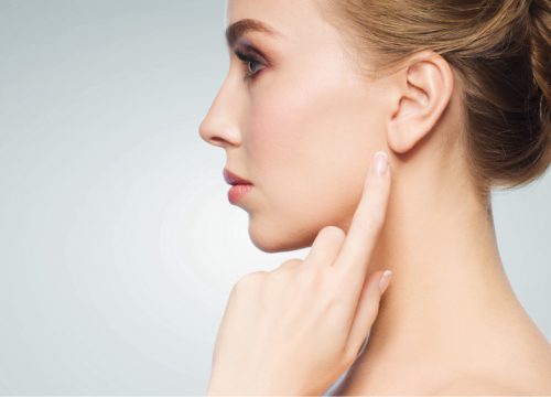 Woman pointing at her ear
