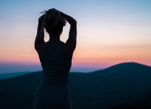 Woman's silhouette watching sunset
