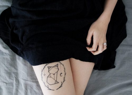 Girl with cat tattoo on her leg
