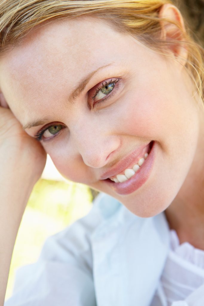 closeup of woman leaning to the left and smiling