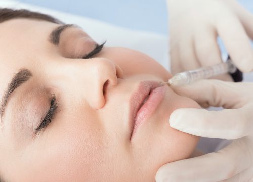 Woman receiving lip filler treatments
