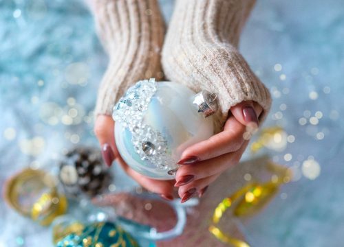 Hands holding a Christmas ornament